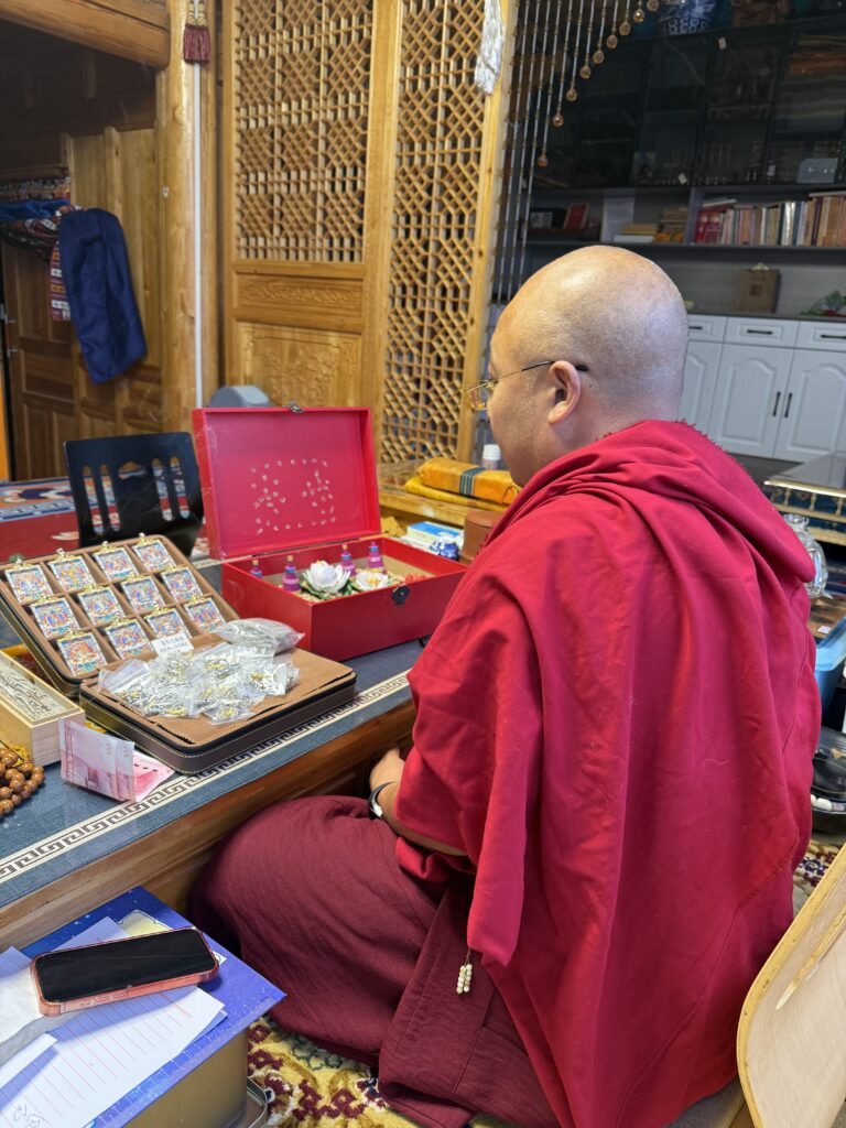 Thangka master working in a traditional art studio